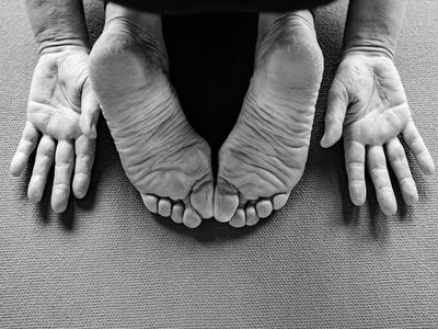 Close-up of feet on a yoga mat finding balance.