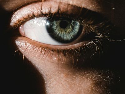 Person taking a deep breath with eyes closed.